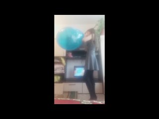 young woman blows up a large balloon in front of a shitty tv until it pops sadlife
