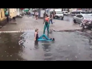 two girls remembered their childhood and swam in a puddle after the rain
